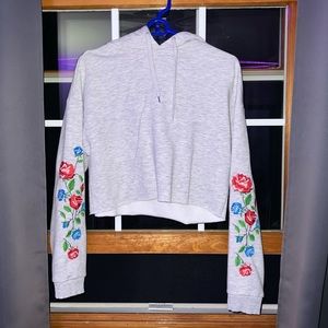 Gray cropped hoodie with roses down the sleeves